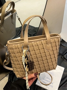 Khaki woven texture bucket bag with chocolate charm and adjustable crossbody strap