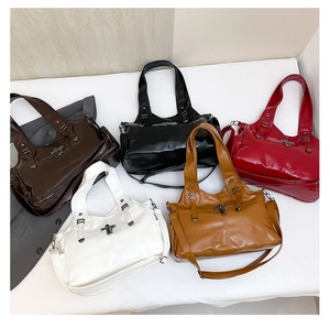 Selection of glossy faux leather tote bags with cross buckle detail and shoulder straps