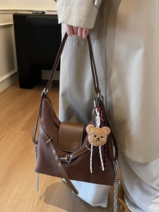 Retro brown oversized nubuck hobo bag with plush bear charm and chain detail