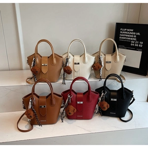 Selection of stylish leather bucket bags in various colors with cute bear pendants
