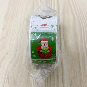 Detailed view of Christmas roll stickers with cartoon Santa and festive greetings in packaging