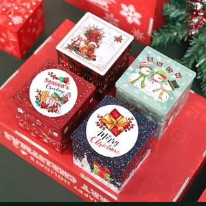 Christmas theme square tinplate gift boxes with festive holiday patterns on red background