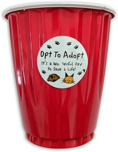 Detail of waterproof animal rescue sticker on a red plastic cup with pet adoption slogan