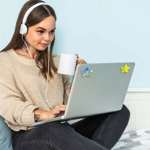 Laser glitter star stickers on a laptop featuring blue-purple gradient and yellow designs