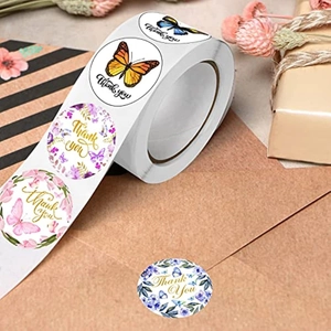 Detailed close-up of floral butterfly thank you stickers for wedding gift packaging