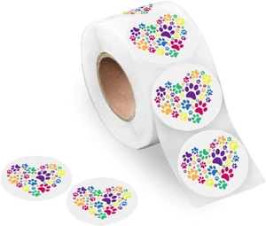 Macro detail of round roll stickers featuring colorful heart-shaped paw print patterns