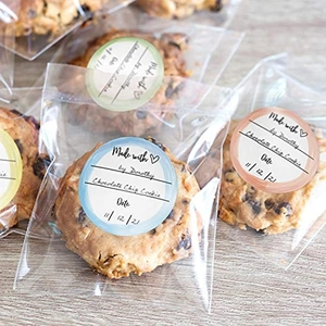 Morandi color labels on transparent cookie bags over warm wood texture background