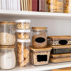 Waterproof removable chalkboard labels on glass food storage jars in a kitchen setting