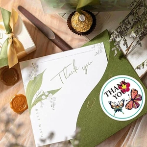 Macro detail of lily of the valley thank you card set with butterfly seal sticker
