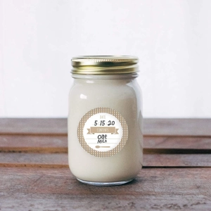 Close-up of kraft paper sticker on a glass jar with date and content handwriting