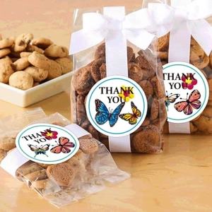 Macro shot of butterfly thank you sticker sealing a clear cookie bag with white bow