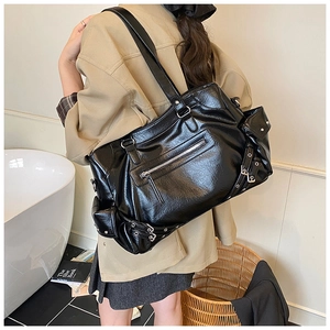 Detail view of a large black vintage motorcycle style tote bag with multiple zippers