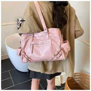 Detailed side view of pink large-capacity leather tote bag with stylish buckles and zippers