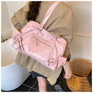 Detailed view of pink glossy PU tote bag with silver zippers and motorcycle style accents