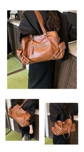 Detail of vintage brown tote bag with metal rivets and functional zipper pockets