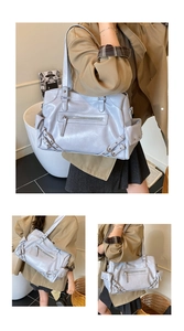 Detail view of a lilac multi-pocket tote bag featuring a textured faux leather finish