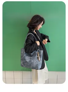 Blue marbled tote bag with wooden bead charm styled as a casual shoulder bag