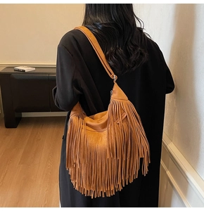 Dettaglio della borsa hobo marrone vintage con fitte nappe scamosciate e tracolla larga