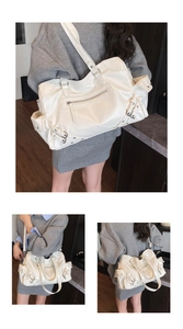 Detailed view of white large capacity tote bag with vintage PU leather and side buckles