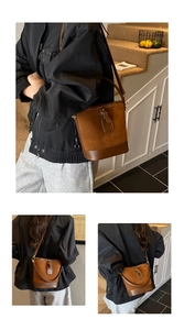 Detail view of brown matte PU bucket bag showing leather splicing and metallic hardware
