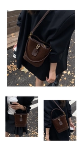 Deep brown matte PU leather bucket bag with top handle and adjustable shoulder strap detail