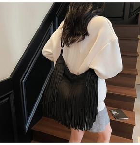 Detailed view of bohemian black fringe shoulder bag with high-quality suede texture