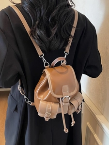 Retro brown leather mini backpack with contrast stitching and adjustable shoulder straps