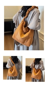 Macro shot of large mustard suede shoulder bag featuring a unique wavy pleated strap