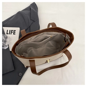 Top view of large canvas tote bag showing spacious interior with zipper pocket and metal lock