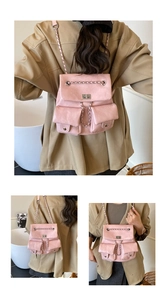 Detail view of pink mini PU leather backpack with silver chain accents and dual pockets