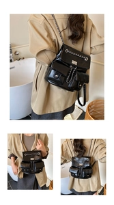 Detail of vintage black PU leather backpack featuring silver chain and metal twist lock
