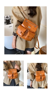 Close-up of vintage brown PU leather backpack with silver chain straps and flap pockets