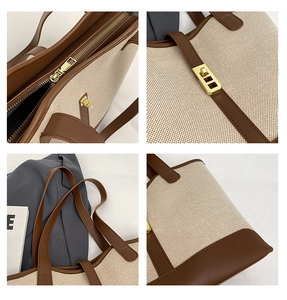 Detailed close-up of canvas tote bag featuring leather stitching and golden hardware locks