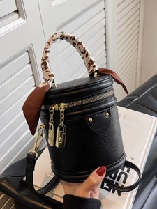 Retro black leather cylinder bucket bag with gold zipper and silk scarf wrapped handle