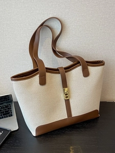 Chic commuter tote bag made of beige canvas and brown faux leather with gold lock
