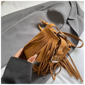 Close-up perspective of a brown vintage matte tassel saddle bag for women's fashion