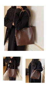Detail of deep brown woven leather texture and handles on the large tote bag