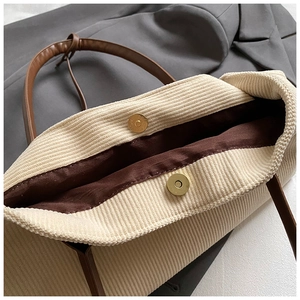 Detail of corduroy tote bag with magnetic metal buckle and premium texture