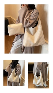 Detail of minimalist woven off-white hobo bag with a matching zippered inner pouch