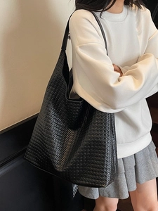 Minimalist black woven faux leather tote bag for women showing spacious hobo style design