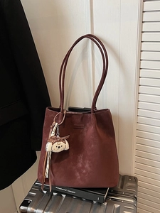 Large burgundy tote bag in soft suede with puppy charm on silver suitcase