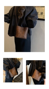 Detail of leopard print mini bucket bag showing the texture and thin shoulder strap