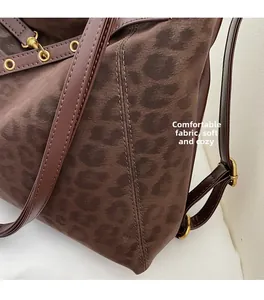 Detail of leopard print tote featuring soft suede texture and adjustable leather strap