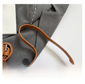 Close-up of adjustable shoulder strap and premium stitching on caramel bow bag