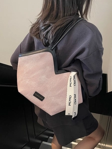 Pink pleated large tote bag with V-shaped opening and black shoulder straps