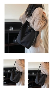Detail view of a large black bucket bag with textured suede and smooth leather finishes