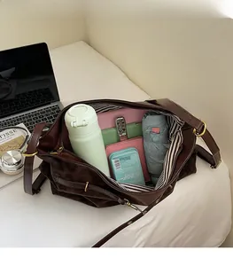 Interior view showing large capacity and striped lining of this brown suede tote bag