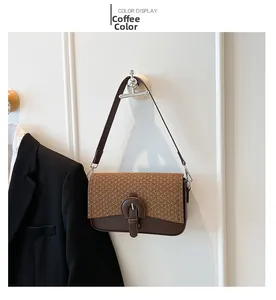 Detail of coffee brown crossbody bag with woven texture and leather flap on wall hook
