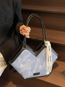Light blue corduroy tote bag with V-shaped leather trim and decorative silk ribbon detail