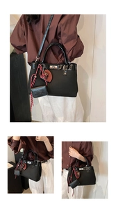 Detail of vintage matte black tote bag with silver turn-lock and woven rope accessory